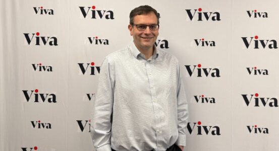 Dave Higgerson in front of a white backdrop with Viva's logo